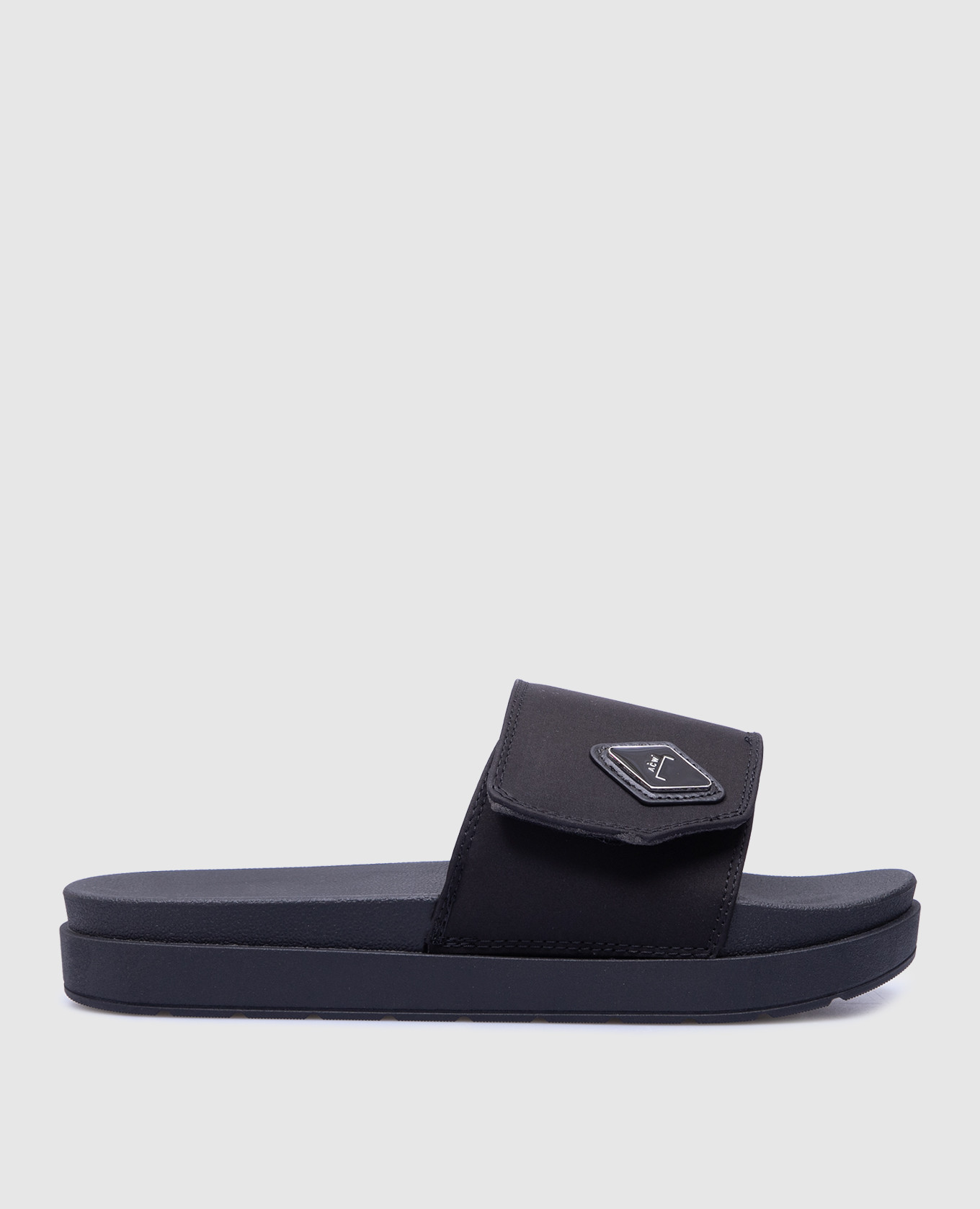 Black sliders with logo a cold wall