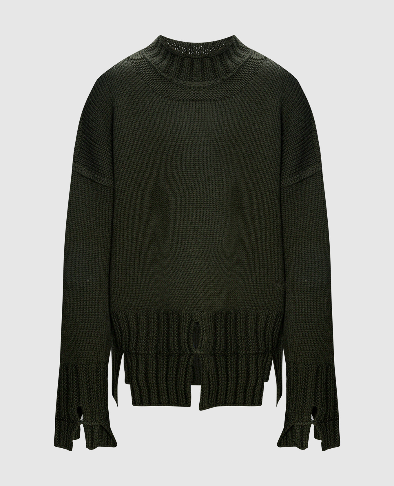 Green sweater made of wool a cold wall